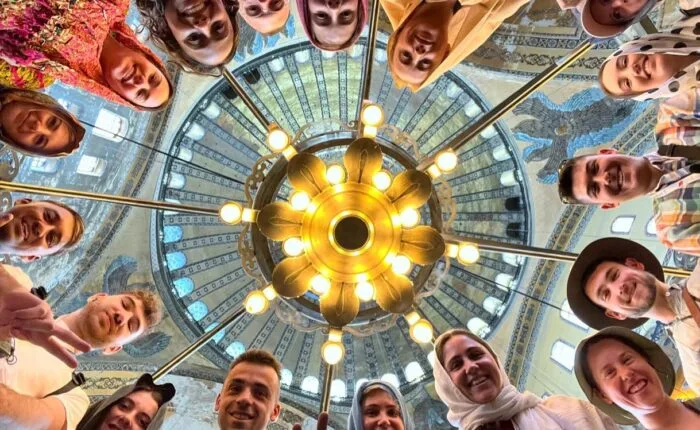 Group photo under a decorative ceiling
